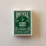 BICYCLE × fragment “FLOWER HUDDLE” グリーンのタックケース正面。ロゴとモデル名が映る実機写真。